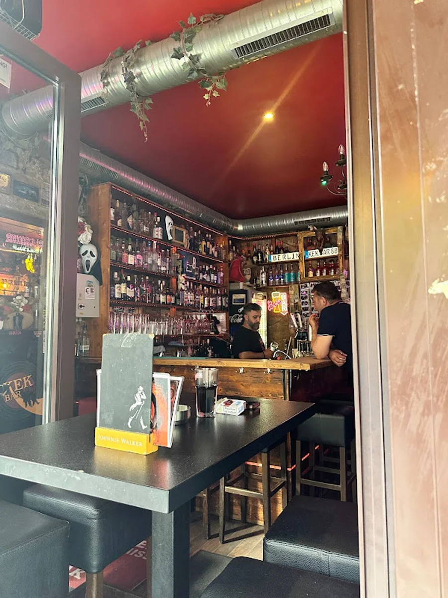 Inside KEK Bar, with its red ceiling and bottle-lined counter